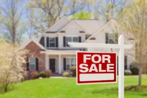 Red For Sale real estate sign in front of a suburban Ottawa house during spring, representing the best time to sell a home.